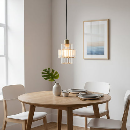 Crystal and gold metal pendant light adding warm elegance above the dining table in modern interiors.