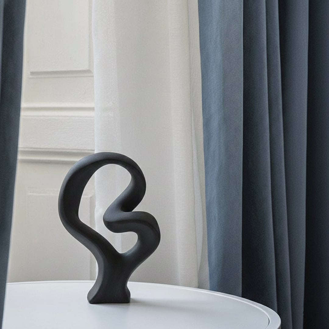 Black abstract sculptural decor object styled on console modern artistic statement accent for living room shelf styling home.