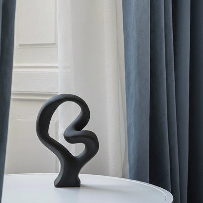 Black abstract sculptural decor object styled on console modern artistic statement accent for living room shelf styling home.