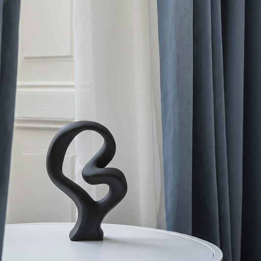 Black abstract sculptural decor object styled on console modern artistic statement accent for living room shelf styling home.