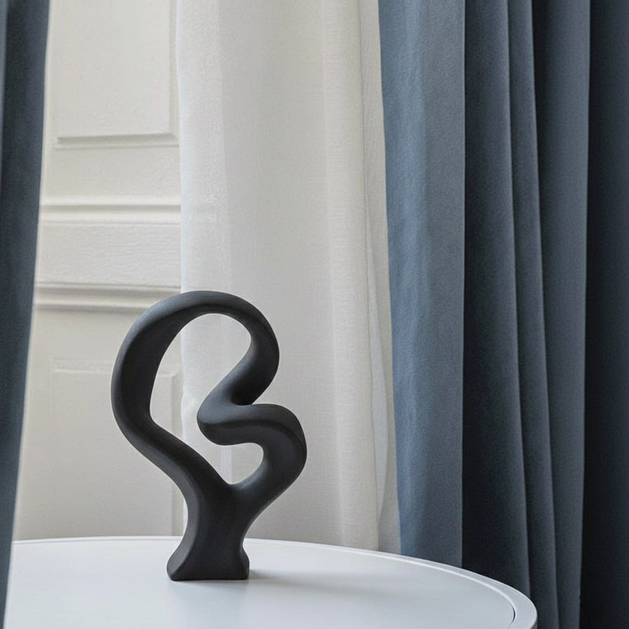 Black abstract sculptural decor object styled on console modern artistic statement accent for living room shelf styling home.