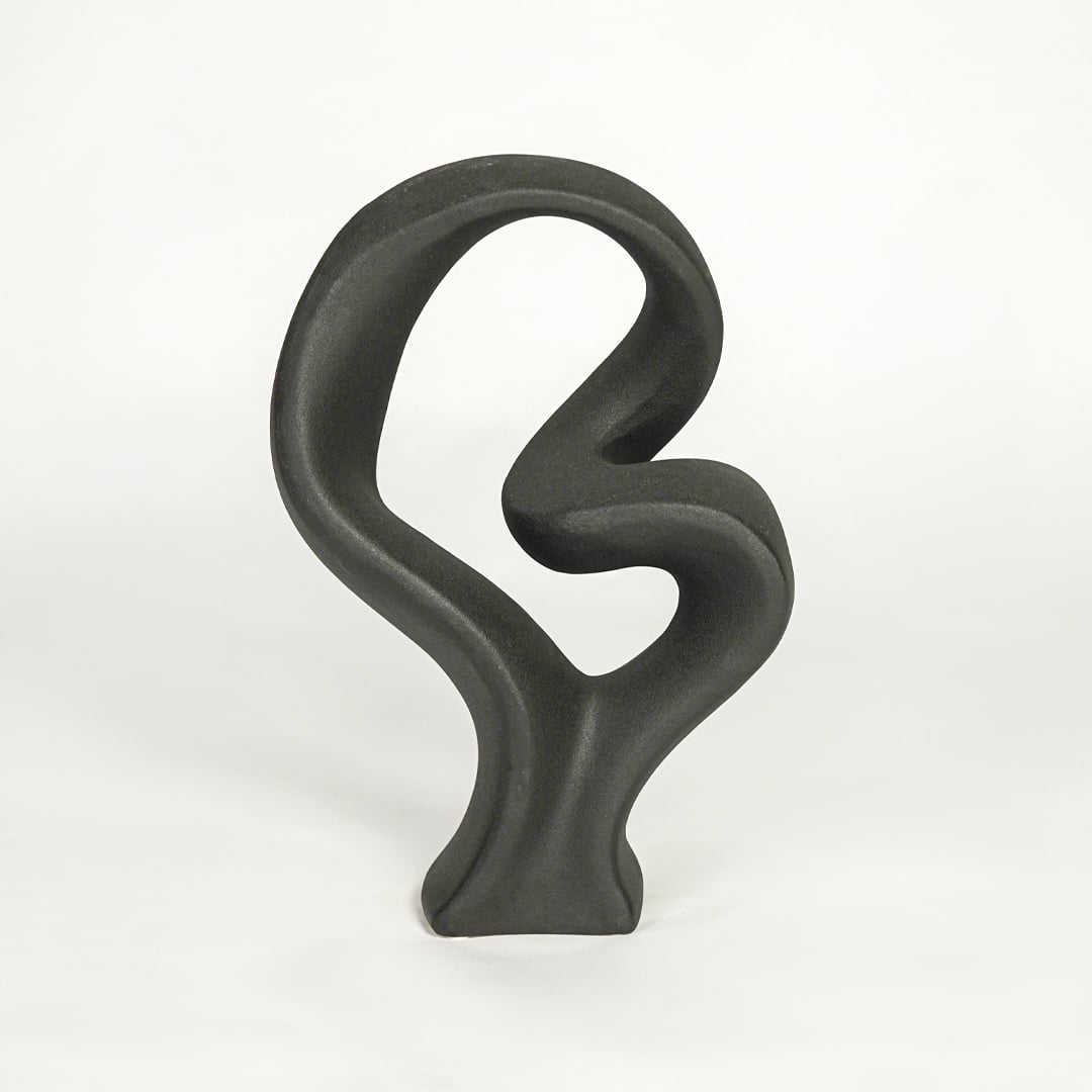 Black sculptural decor object on white background modern abstract statement piece for contemporary interior styling.
