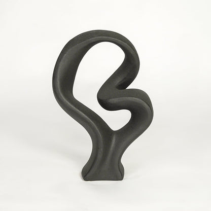 Black sculptural decor object on white background modern abstract statement piece for contemporary interior styling.