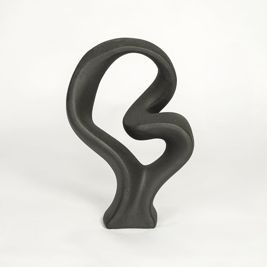 Black sculptural decor object on white background modern abstract statement piece for contemporary interior styling.