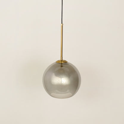 Smoked glass globe pendant light with gold cord for refined contemporary interiors.
