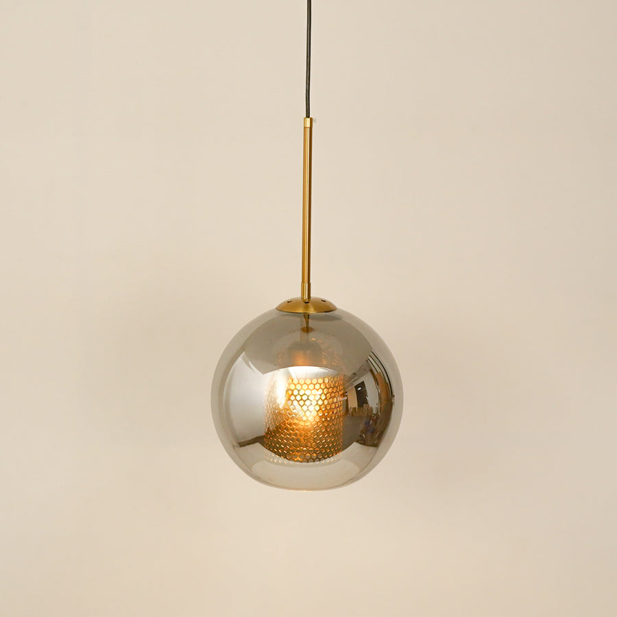 Smoked glass globe pendant light illuminated softly for elegant ceiling lighting.