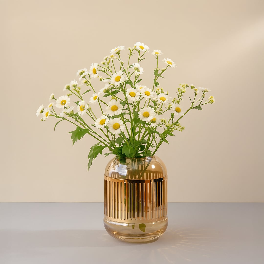 Glass vase with white daisy flowers styled on table creating fresh natural look and soft elegant accent for home Decor.