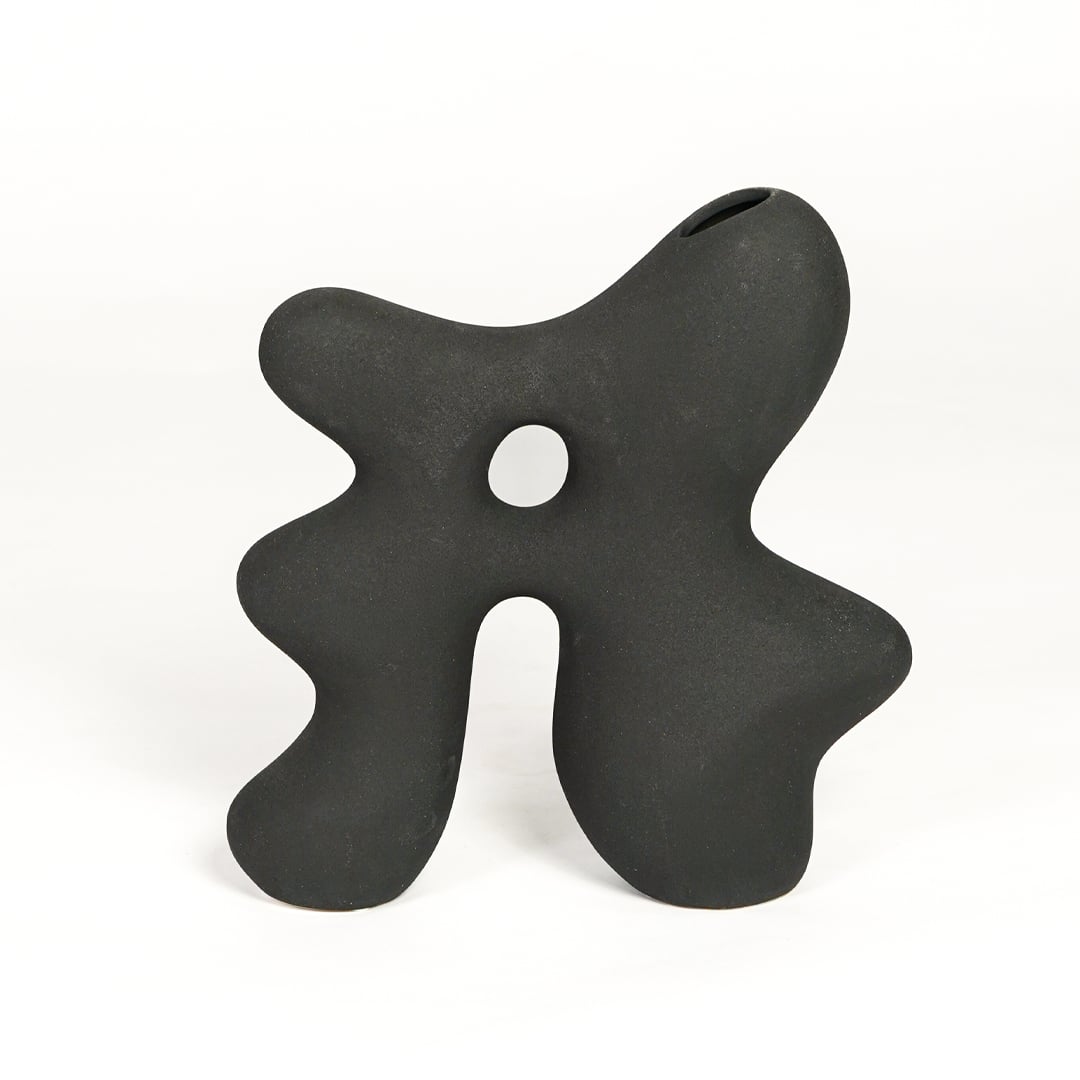 Modern dark grey ceramic statement decor vase with unique hollow center for minimalist interiors.