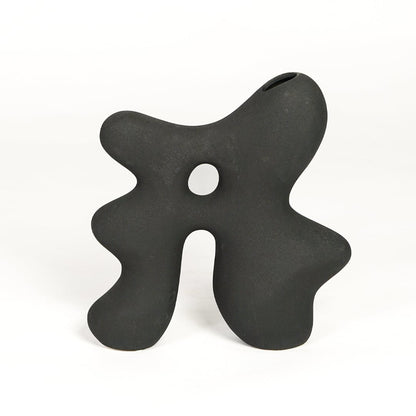 Modern dark grey ceramic statement decor vase with unique hollow center for minimalist interiors.