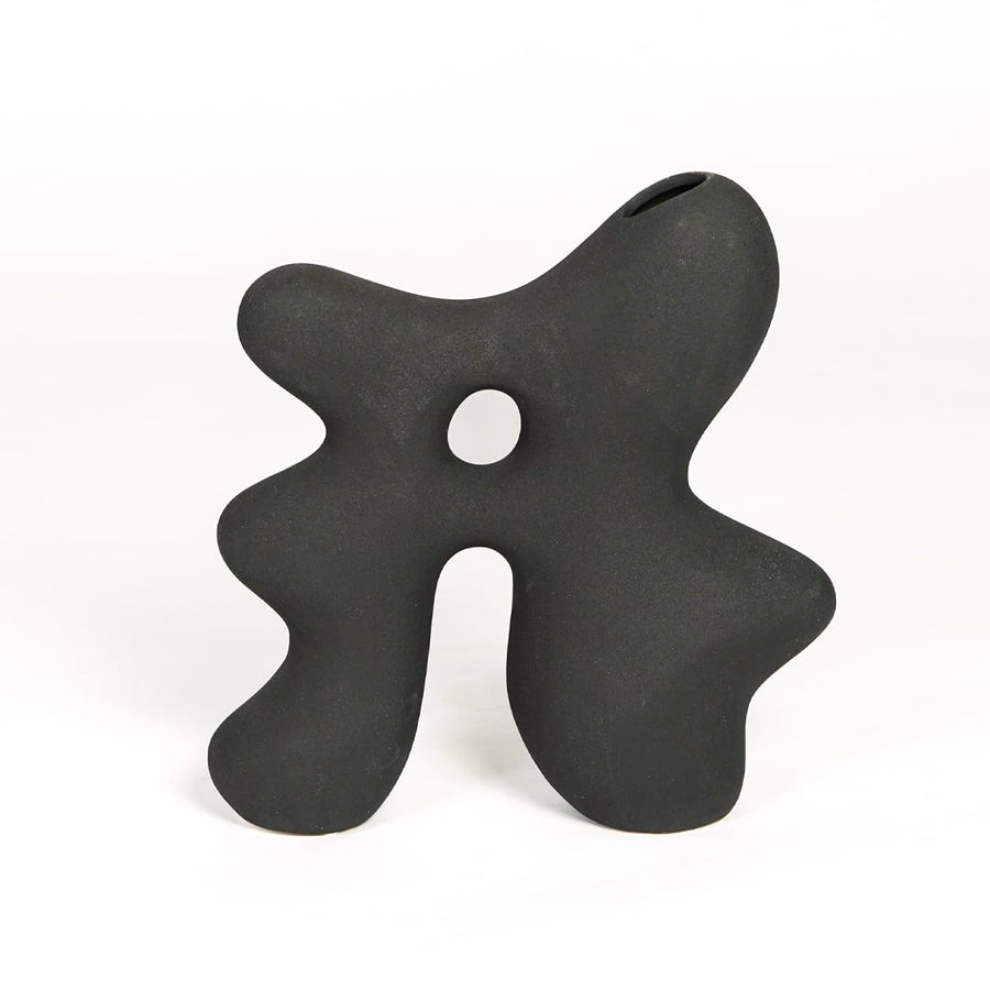 Modern dark grey ceramic statement decor vase with unique hollow center for minimalist interiors.