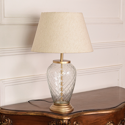 Gold metal table lamp with crystal glass base and fabric shade for luxury tabletop lighting decor styling ideas.