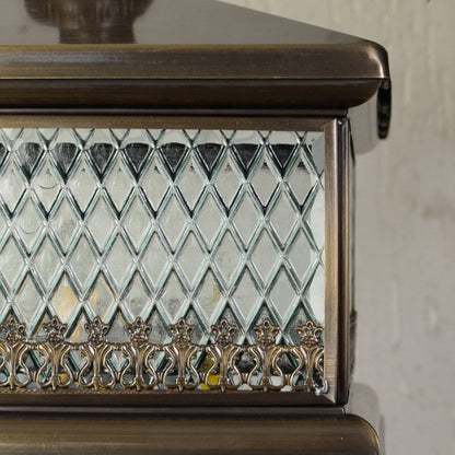 Close view of outdoor pillar light with textured patterned glass and metal frame showcasing durable weather resistant exterior lighting design.