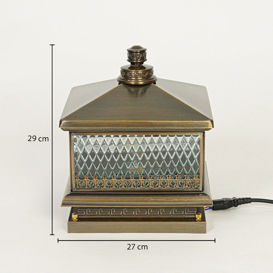 Vintage outdoor pillar light with antique metal finish and patterned glass panels on neutral background 29 cm height 27 cm width ideal for exterior decor lighting.