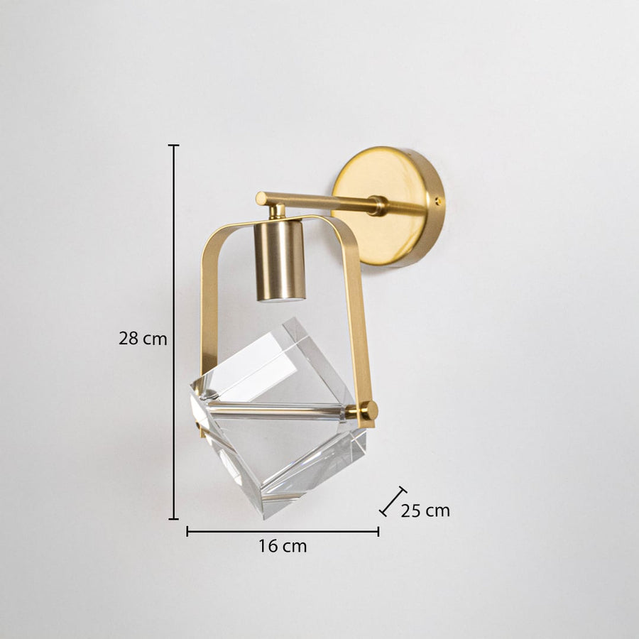 Modern brass gold wall sconce with crystal cube shade showing 28cm height 16cm width 25cm depth dimensions on white background.