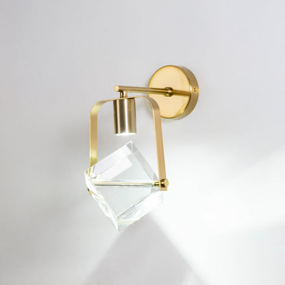 Gold metal crystal wall light on white background with geometric glass shade for luxury modern wall decor.