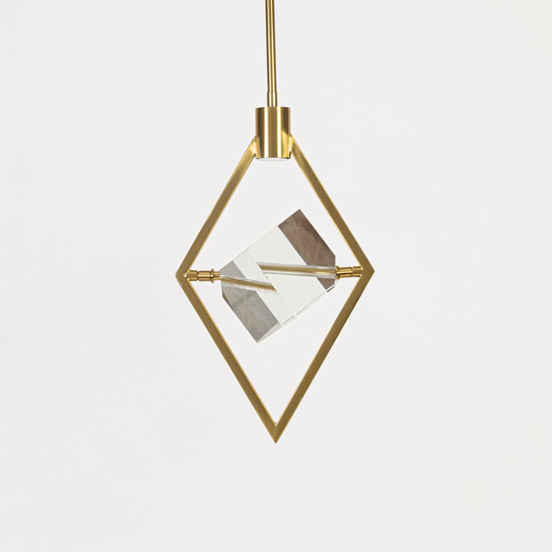 Pendant light with golden diamond frame and crystal centerpiece shown off on white background for interiors.