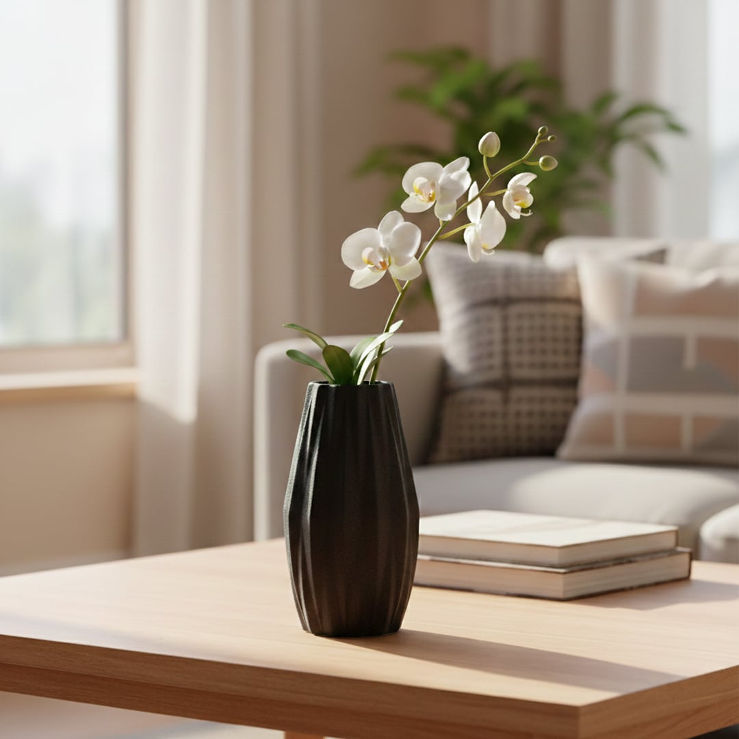 Black textured ceramic decorative vase styled with orchid stem on wooden coffee table in bright modern living room setting.