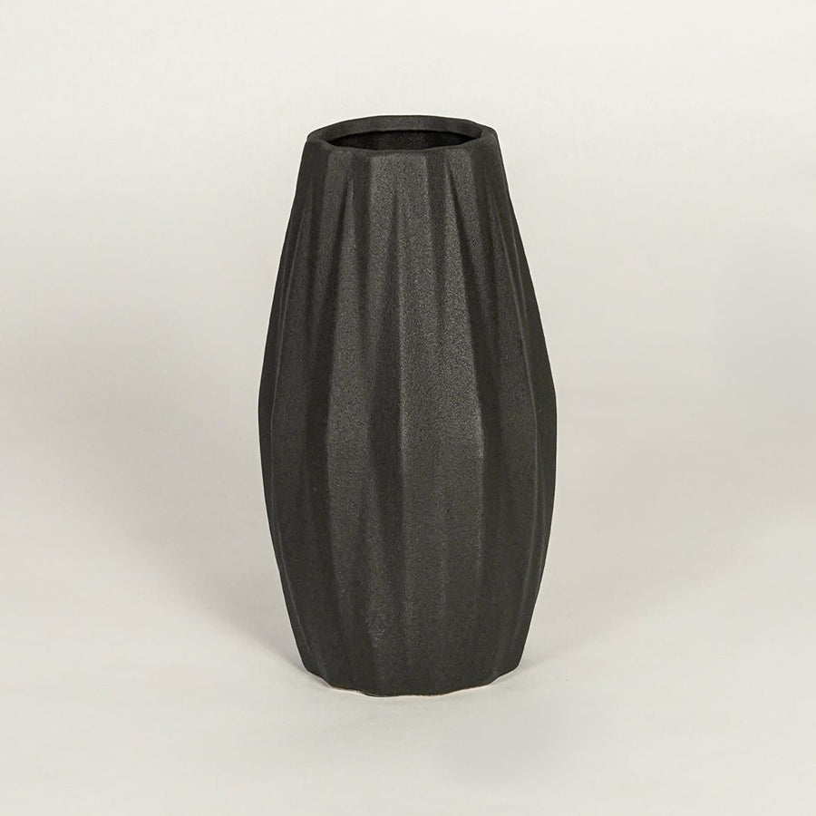 Modern black ceramic statement vase with sculpted ribbed body for coffee table console or shelf display.