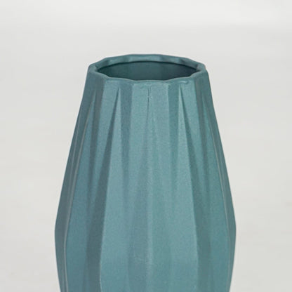 Closeup green textured ceramic vase surface detail modern decorative flower vase for table shelf console decor.