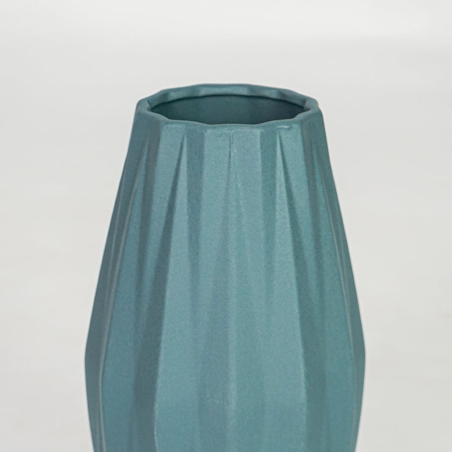Closeup green textured ceramic vase surface detail modern decorative flower vase for table shelf console decor.