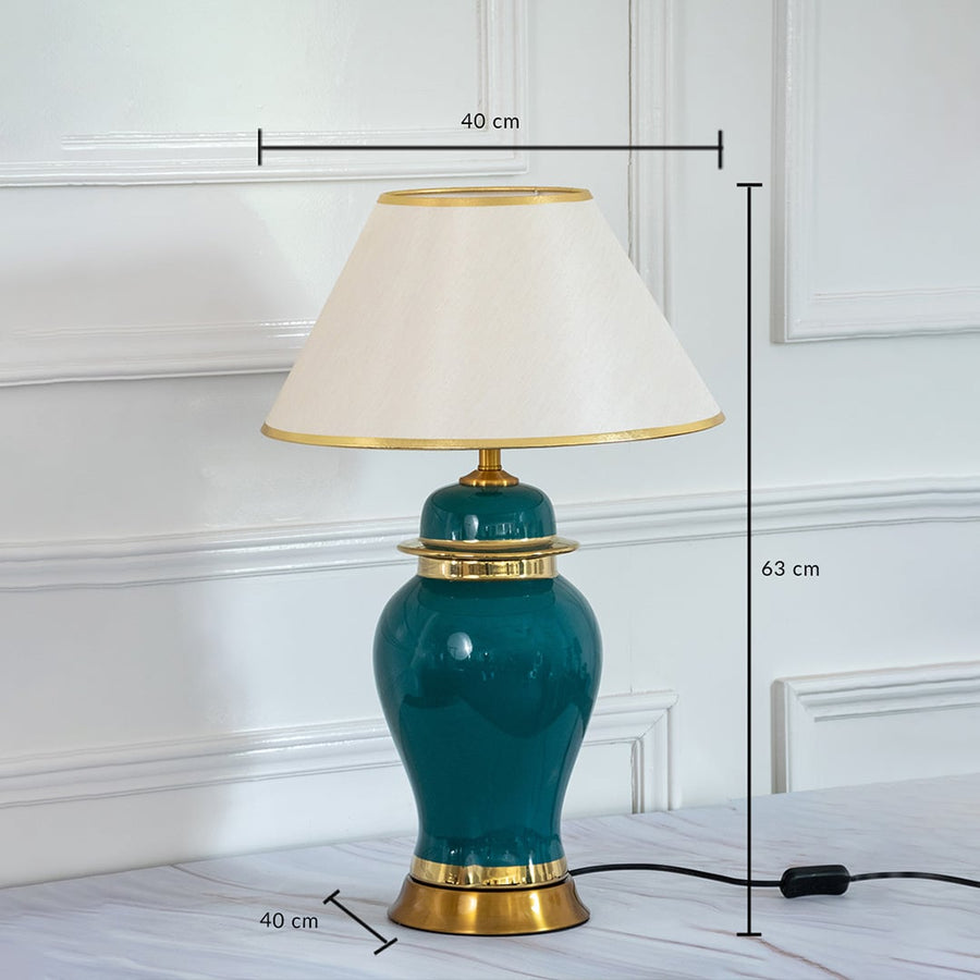 Green ceramic table lamp with golden base and shade showing 63 cm height and 40 cm width dimensions.