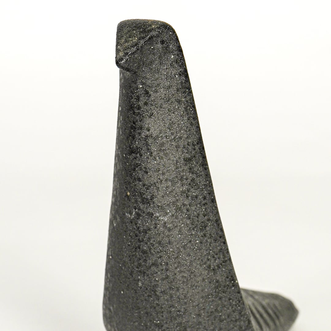Closeup of dark grey ceramic abstract animal decor sculpture showing textured finish and sculpted form.