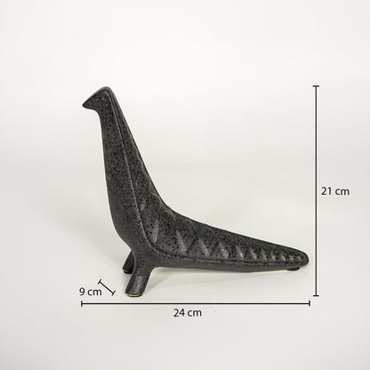 Dark grey ceramic decor sculpture showing 24 cm length 21 cm height and 9 cm width on white background.