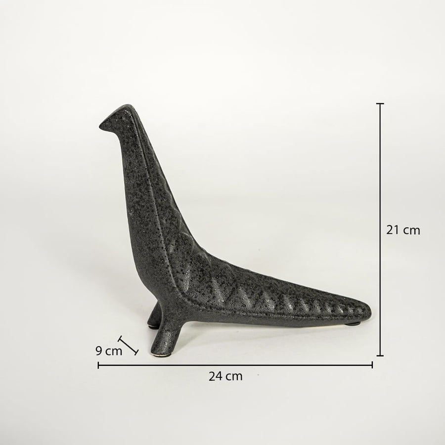 Dark grey ceramic decor sculpture showing 24 cm length 21 cm height and 9 cm width on white background.