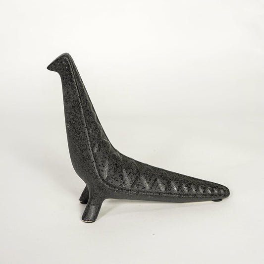Modern dark grey ceramic decorative animal figurine with elongated body isolated on white background.