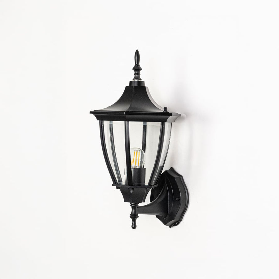 Black exterior wall lantern with light switched off displayed on white background showing metal finish glass panels and mounting details.