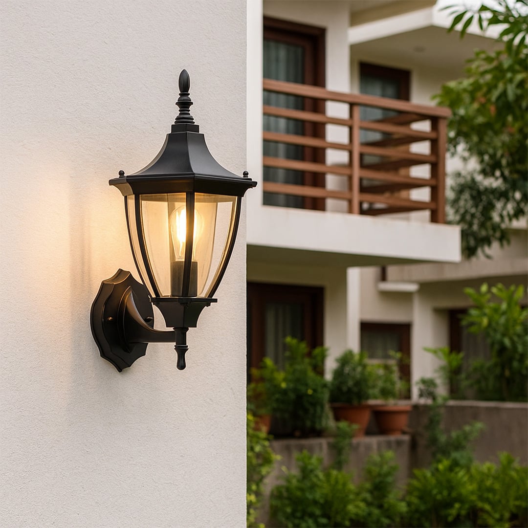 Classic black outdoor wall lantern mounted on exterior wall creating a timeless home entrance look with clear glass panels and vintage styling.