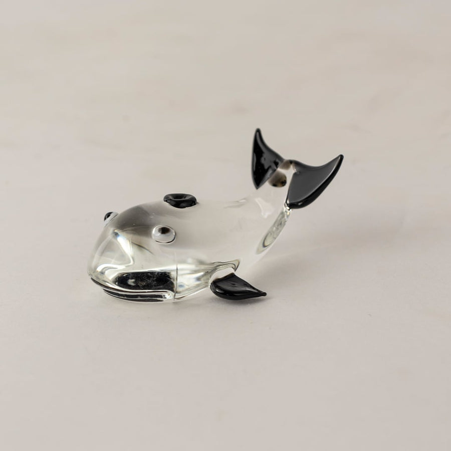Clear glass fish decorative accent with black tail fin for modern tabletop shelf and console decor placement.