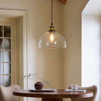 Lifestyle image of transparent dome hanging light for elegant dining room decor styling and modern home lighting design.