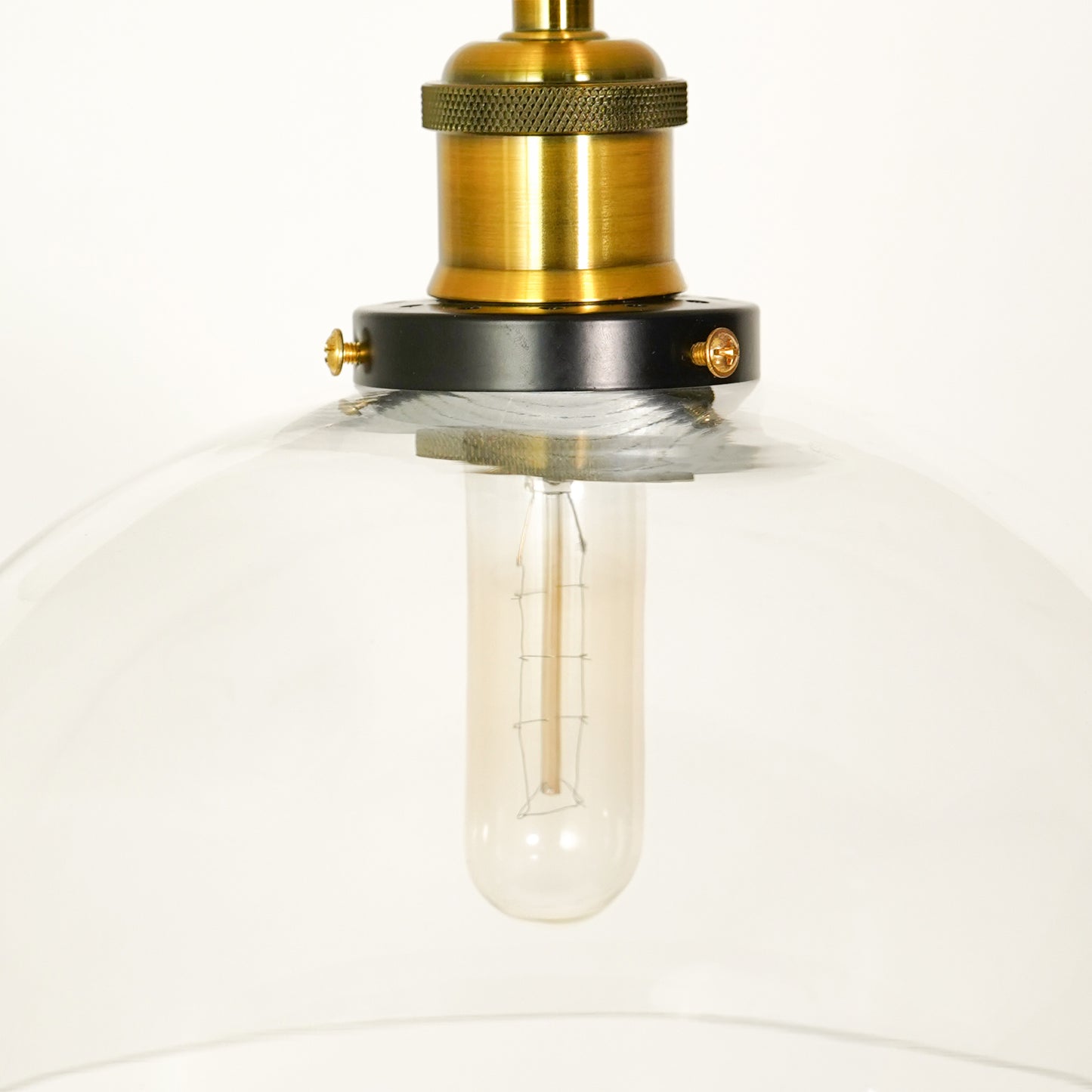 Closeup image of transparent dome hanging light for elegant living room decor styling highlighting sleek glass finish.