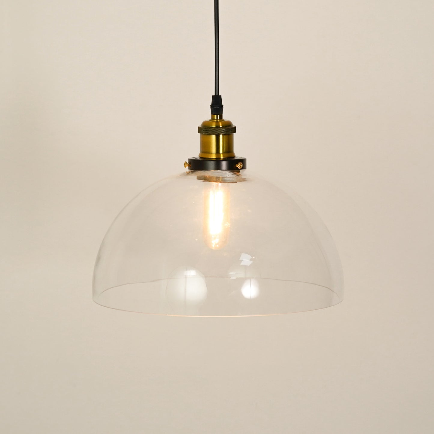 White background image of transparent dome hanging light illuminated for modern living room decor styling and home lighting.