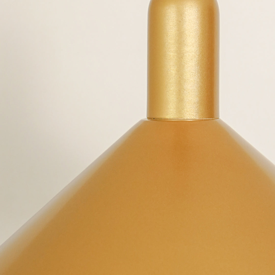 Closeup of matte gold metal pendant light showcasing textured finish and refined craftsmanship.