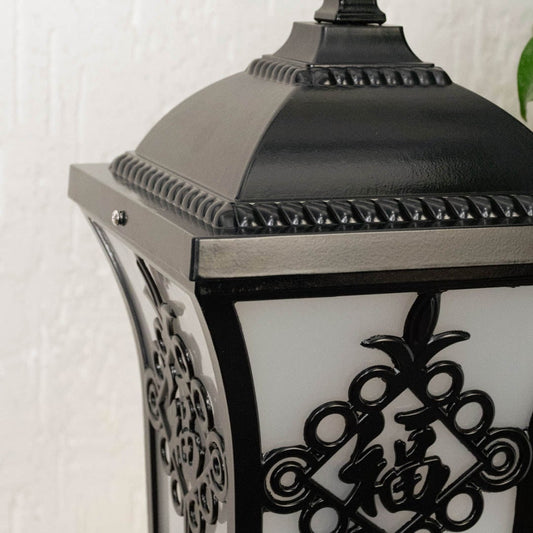 Black outdoor lantern Closeup seeded glass Light On showing the warm ambient glow and decorative pebbled glass panels detail.