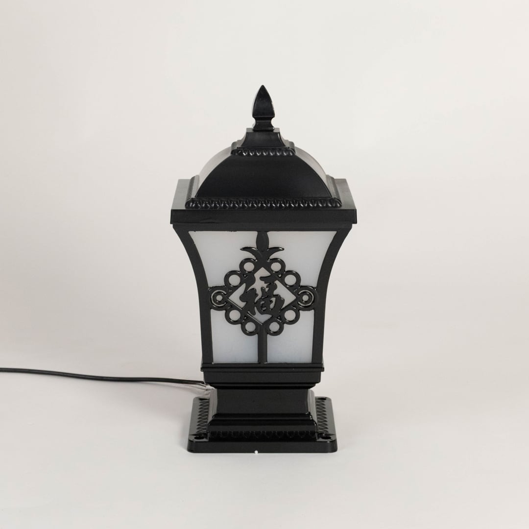Black outdoor post light seeded glass Light Off Black Background style image showing the durable metal fixture next to a tree.