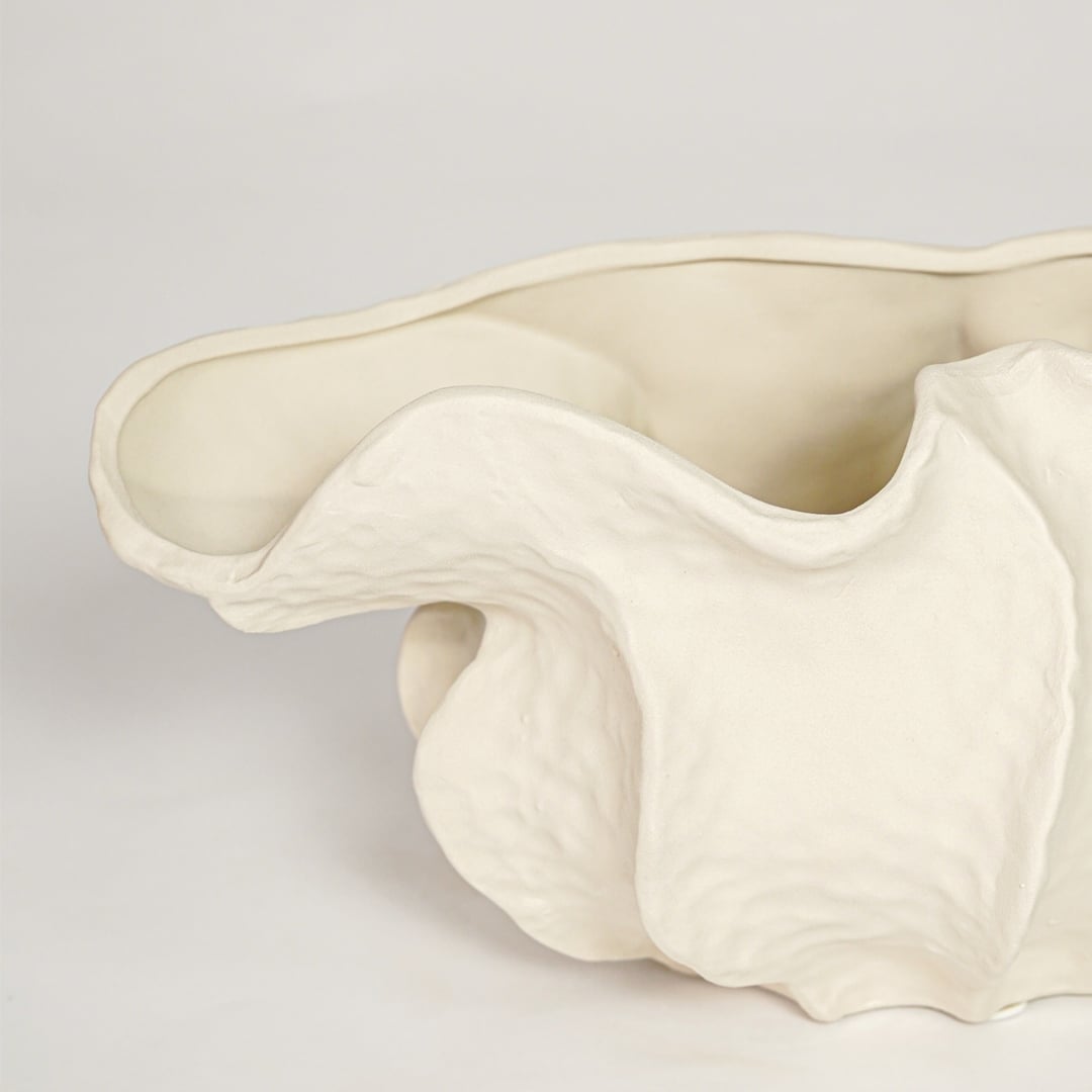 Close view of white doof table ceramic vase small featuring flowing organic form and soft matte finish.