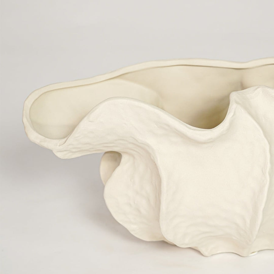 Close view of white doof table ceramic vase small featuring flowing organic form and soft matte finish.