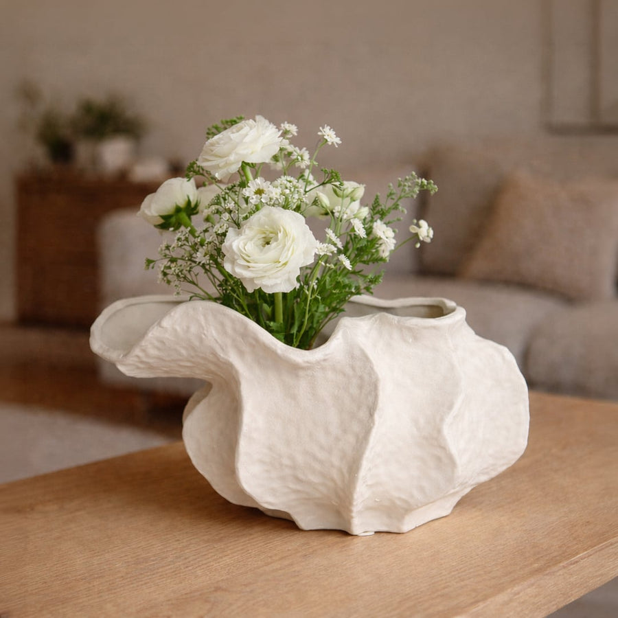 White ceramic abstract decorative bowl styled with fresh flowers enhancing soft and sophisticated home decor setting.