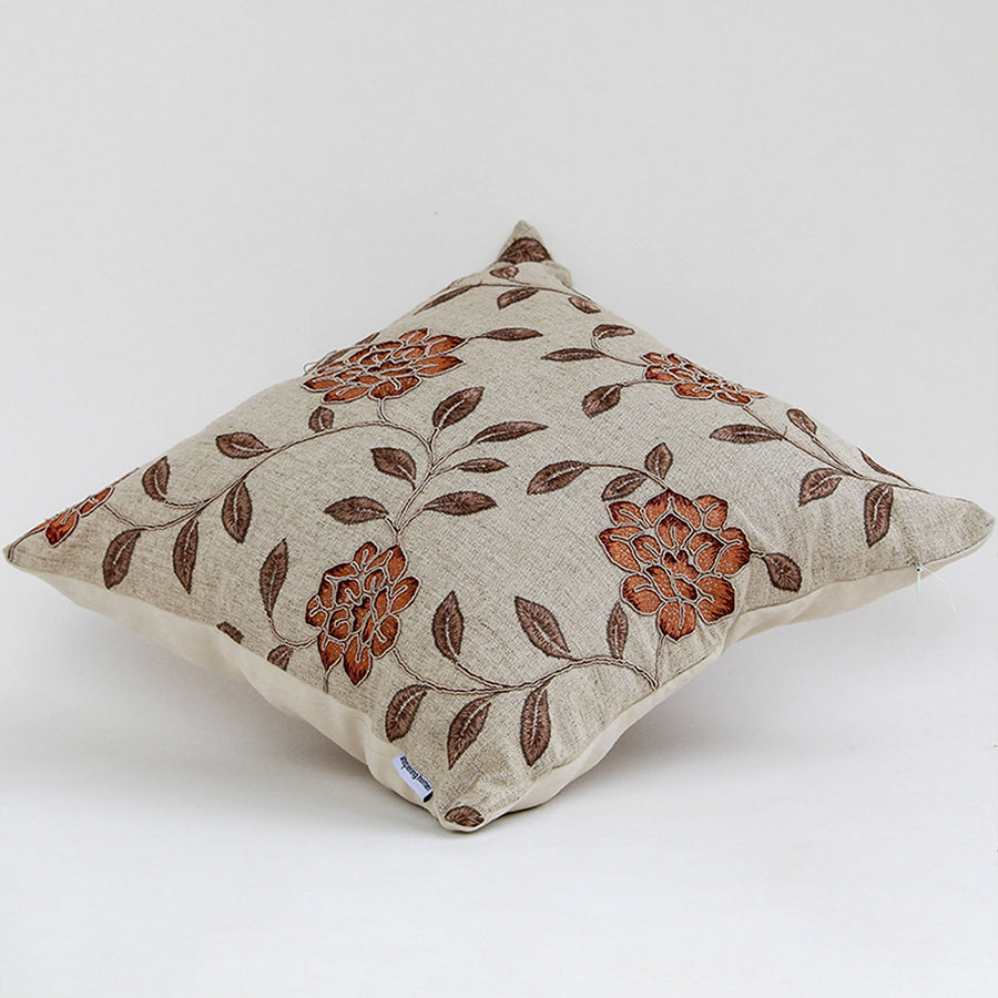 Side view of beige cushion cover with intricate floral pattern soft fabric feel and classic decorative cushion appearance.