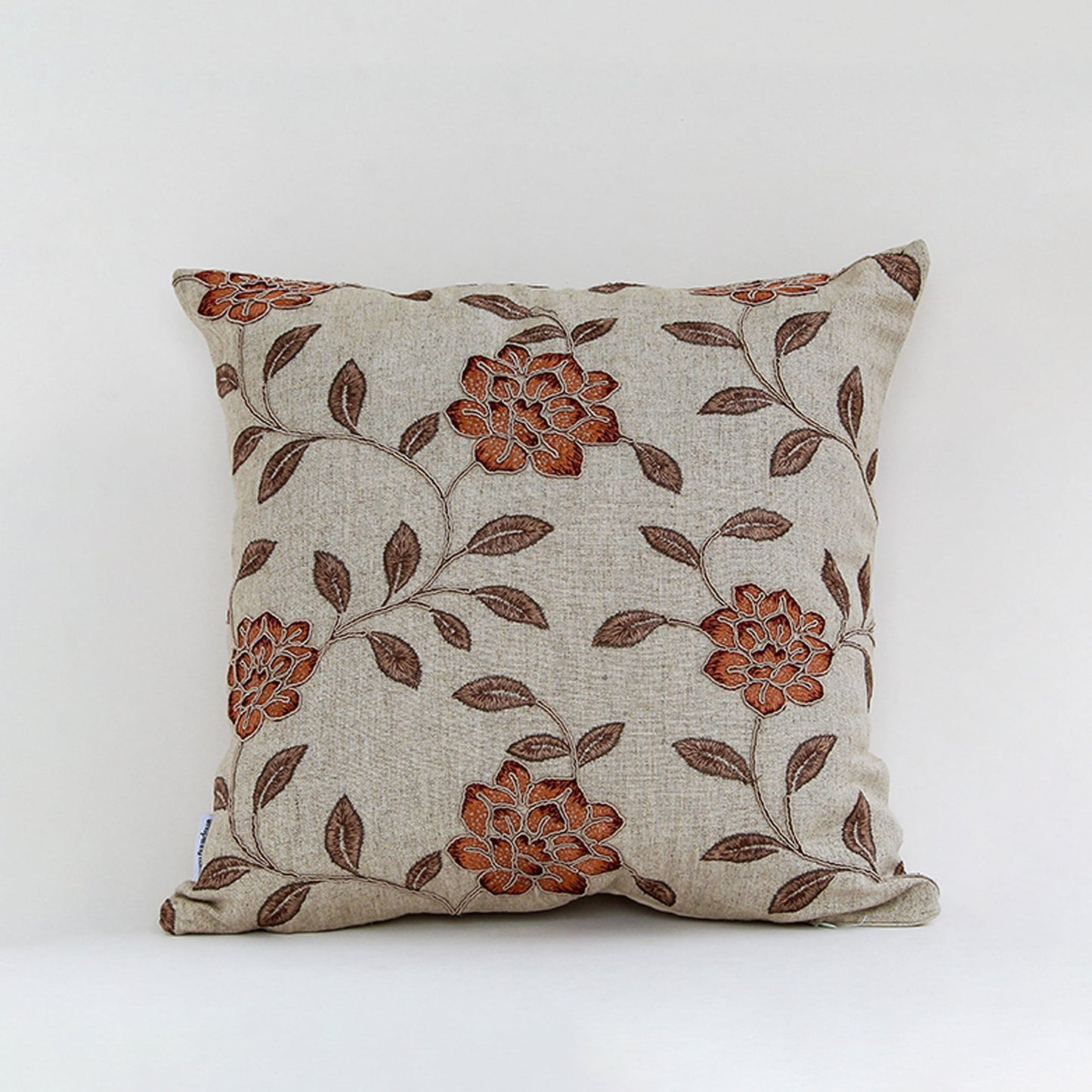 Beige cushion cover with brown floral print on textured fabric designed for sofa chair and bed home decor styling.