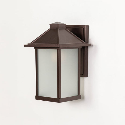 Brown metal wall mounted outdoor lantern switched off on white background emphasizing clean structure and frosted glass panels.