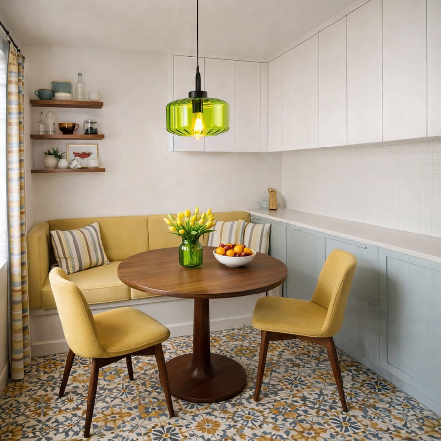 Green metal pendant light suspended above dining table creating vibrant modern lighting in a stylish dining space.
