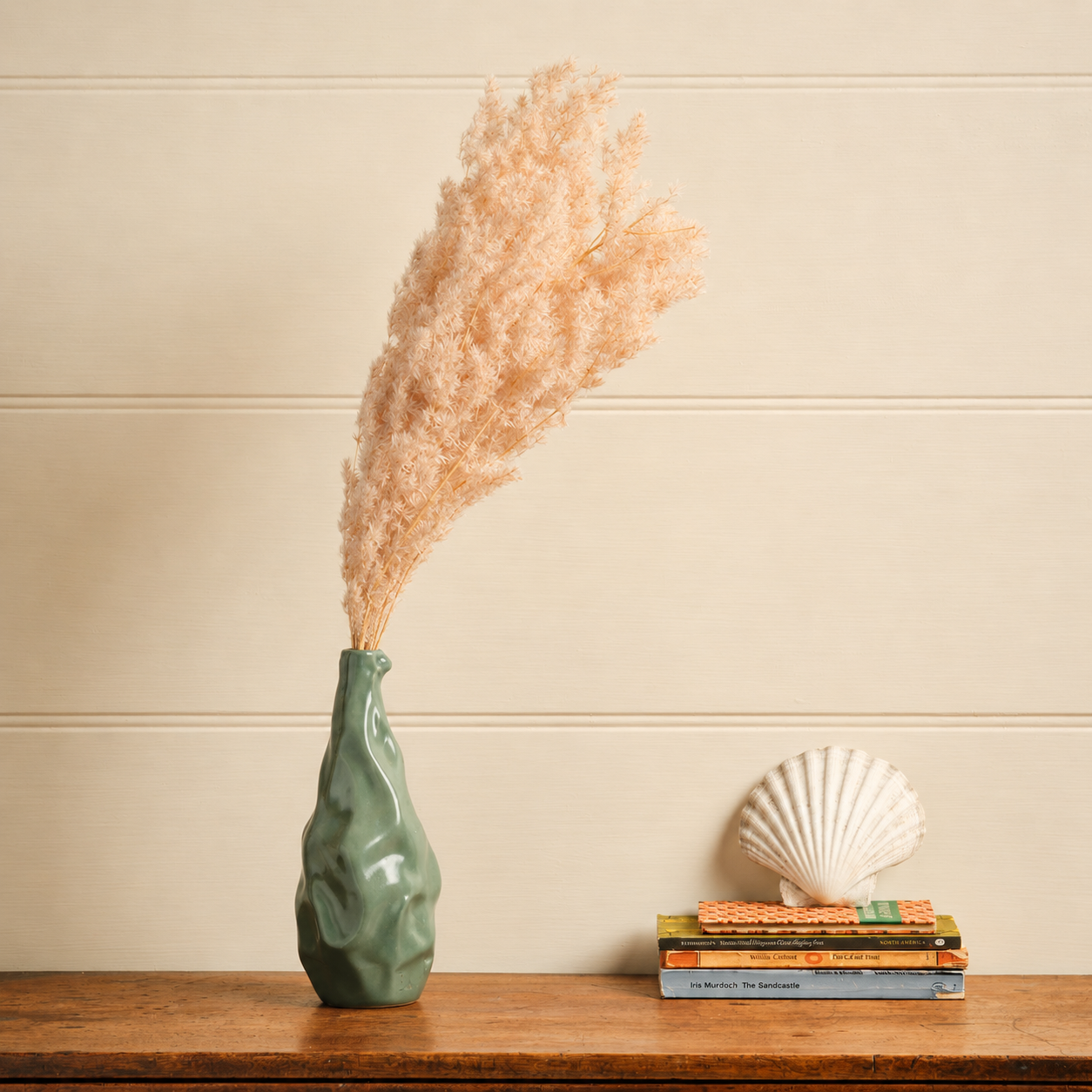 Lifestyle image of pink dried fern asparagus for elegant home interior decor styling and modern room tabletop decoration.