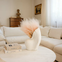 Peach dried pampas grass bunch held in hand perfect for boho home decor and vase styling adds soft natural charm.