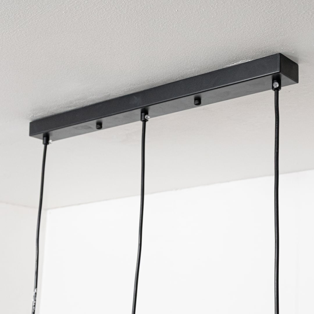 Black metal linear ceiling canopy with hanging cords highlighting premium finish and craftsmanship.
