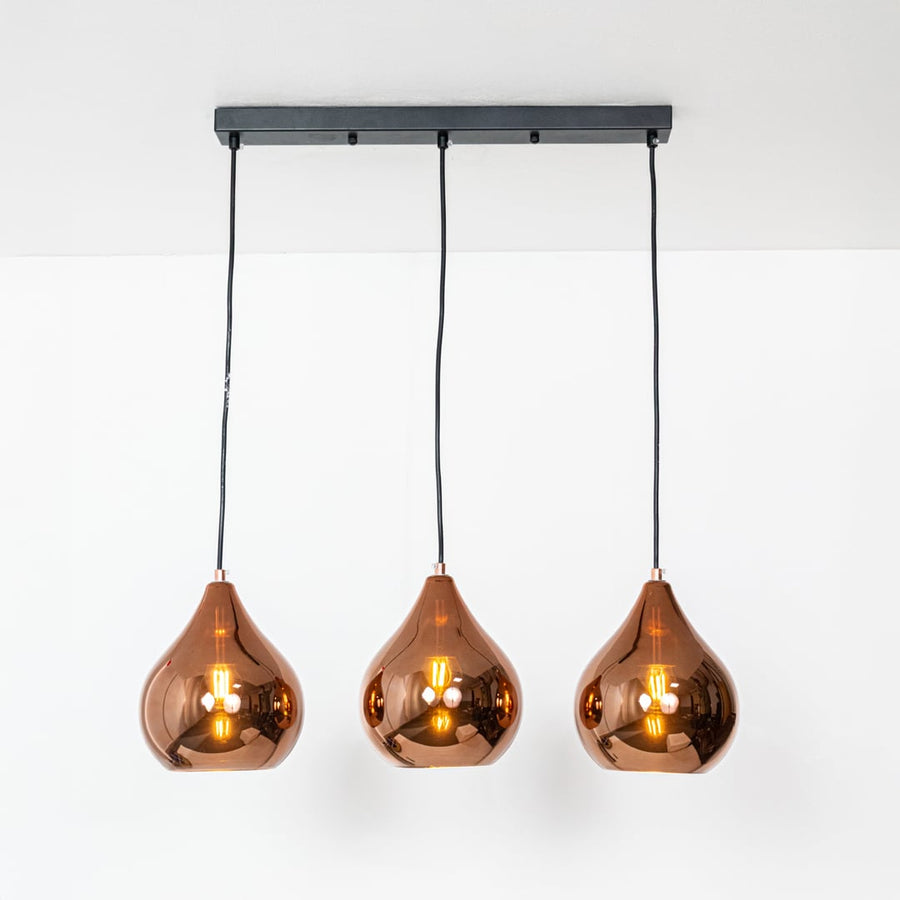 Amber glass pendant lights with metallic finish designed for stylish contemporary home decor spaces.