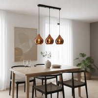 Amber glass pendant lights adding warm elegance above the dining table in modern interior spaces.